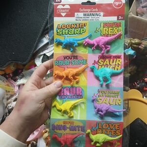 pack of Dinosaur Valentine Exchange Cards with attached plastic dinosaur figures
